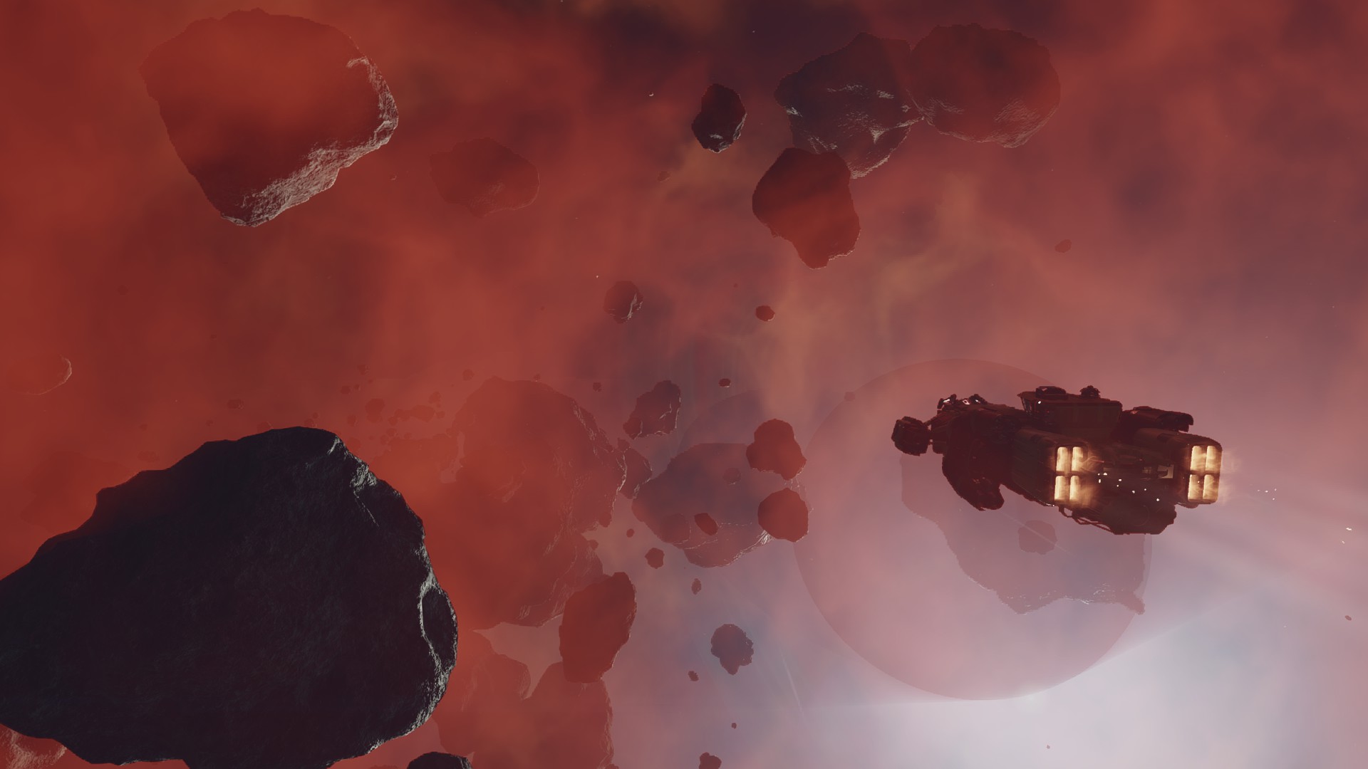 Starfield screenshot of a ship flying through a red gaseous nebula and asteroids