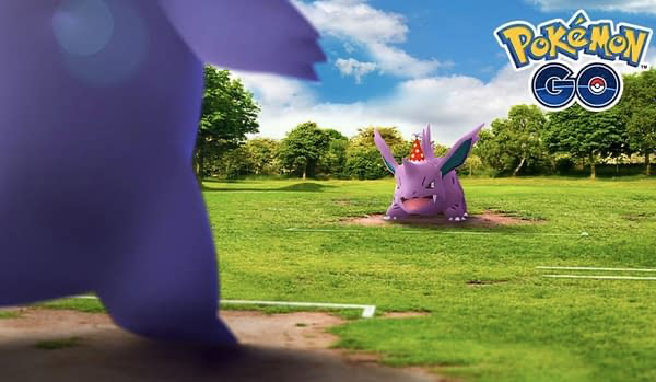 An image of Party Hat Nidorino preparing to battle Gengar in Pokémon GO.