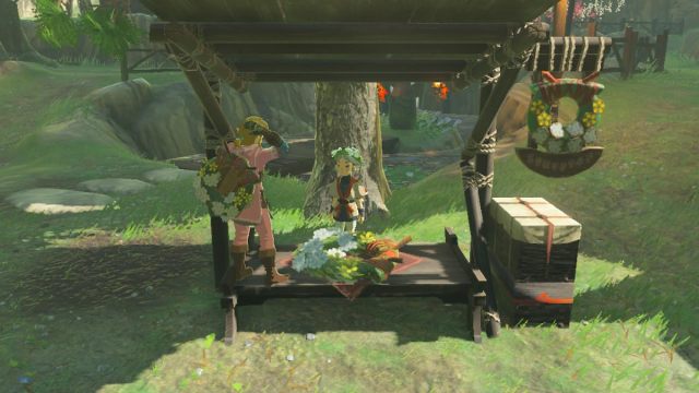 Link and Koko at ring garland stand in Kakariko Village in Tears of the Kingdom