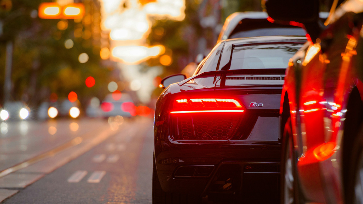 A photograph of two cars from behind.